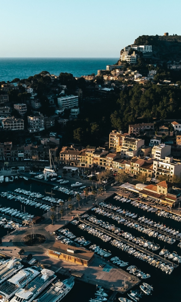 An aerial view of boats in the harbor in Mallorca, Spain with the city in the background
